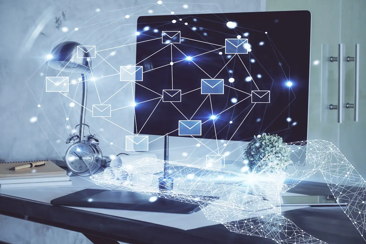 Desktop computer background in office and flying envelops hologram drawing Multi exposure Electronic mail concept